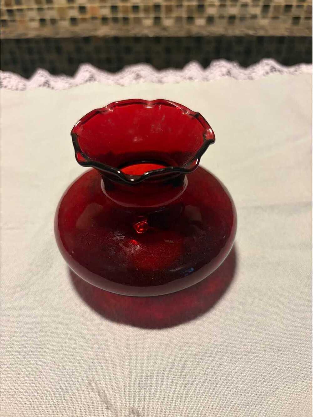 This is a mid-20th century Anchor Hocking Royal Ruby red glass ruffled bud vase.